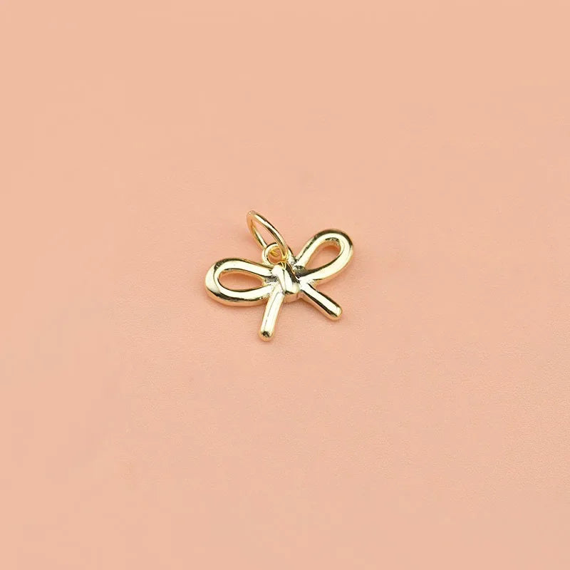 Dije Moño Plateado o Dorado