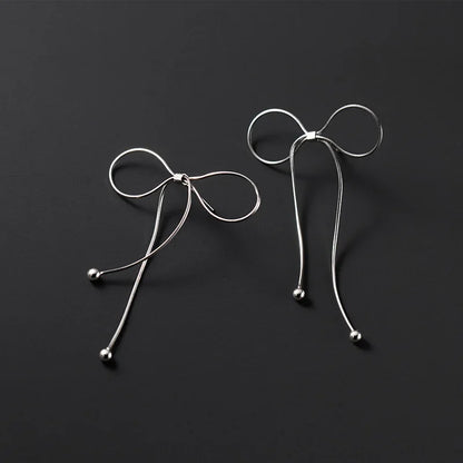 Aretes Moño con Flecos