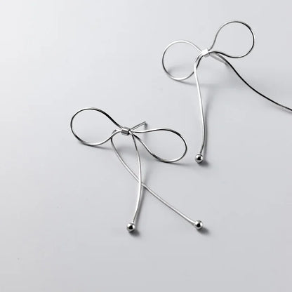 Aretes Moño con Flecos